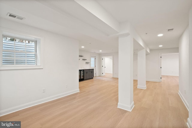 basement with light hardwood / wood-style flooring