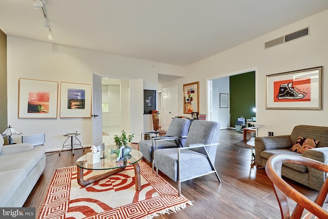 living room with wood-type flooring and track lighting