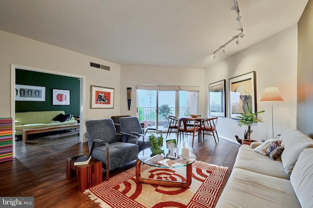 living room with track lighting and dark hardwood / wood-style floors