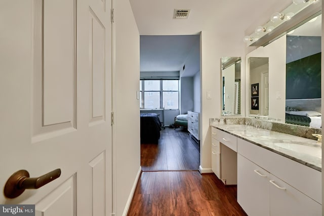 bathroom with wood-type flooring and vanity