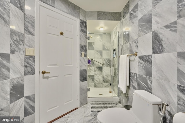 bathroom with tile walls, an enclosed shower, and toilet