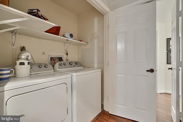 laundry room featuring wood-type flooring and washing machine and dryer