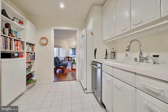 kitchen with white cabinets, dishwasher, light hardwood / wood-style floors, and white fridge