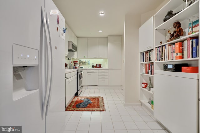 kitchen featuring light tile patterned flooring, white cabinetry, and stainless steel appliances