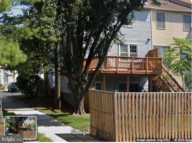 rear view of house with a wooden deck