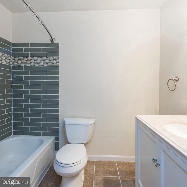 full bathroom featuring tile patterned floors, tiled shower / bath, vanity, and toilet