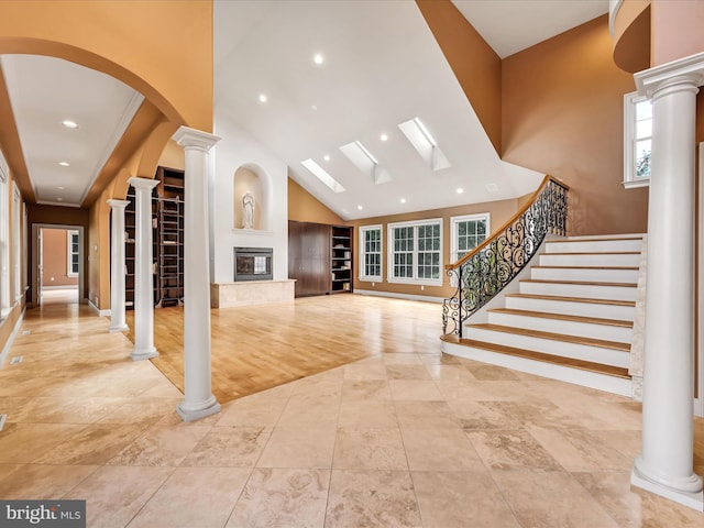 unfurnished living room featuring light hardwood / wood-style flooring and high vaulted ceiling