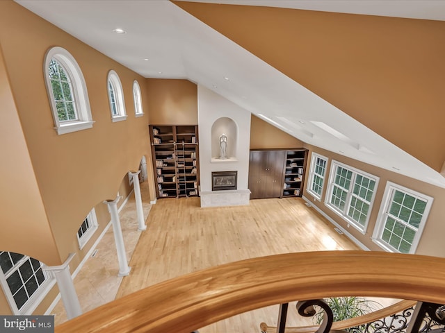 52 Violets Path, Elizabethtown, PA 17022 - unfurnished living room with vaulted ceiling, wood finished floors, a glass covered fireplace, and recessed lighting