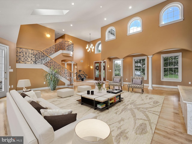 52 Violets Path, Elizabethtown, PA 17022 - living room featuring arched walkways, a high ceiling, wood finished floors, decorative columns, and recessed lighting