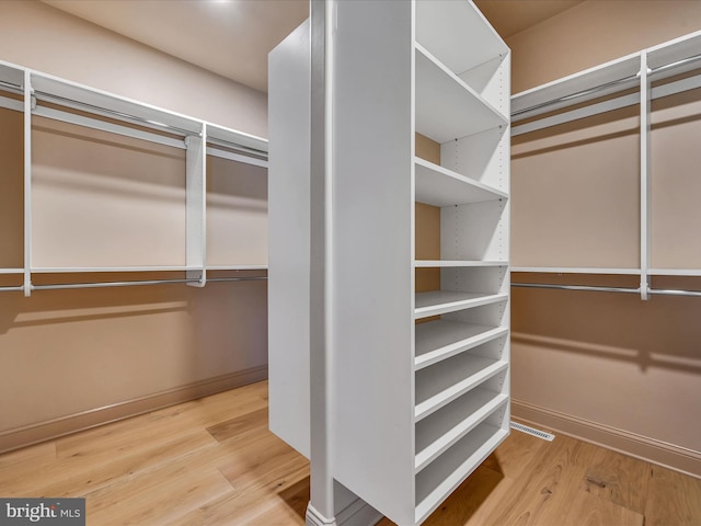 walk in closet featuring hardwood / wood-style flooring