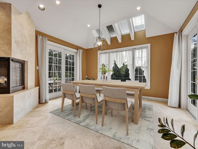 tiled dining area with an inviting chandelier and vaulted ceiling