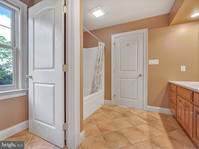 bathroom with vanity, tile patterned floors, and shower / bath combo with shower curtain