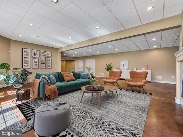 52 Violets Path, Elizabethtown, PA 17022 - living area with a paneled ceiling, baseboards, finished concrete flooring, recessed lighting, and a fireplace