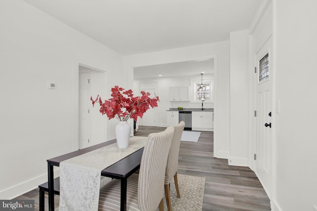 dining room with dark wood-type flooring and sink