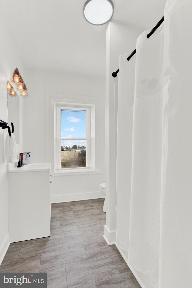 bathroom with vanity and toilet