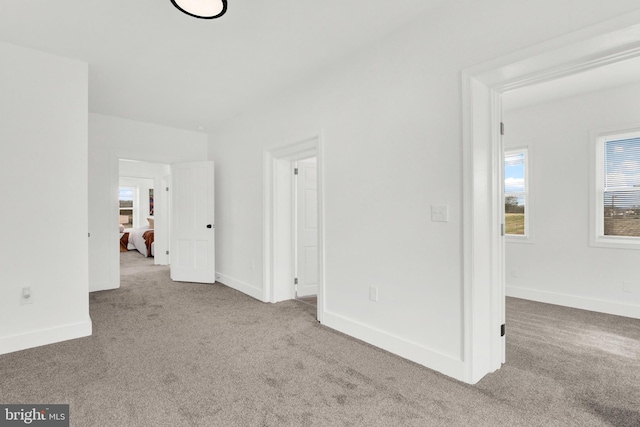 unfurnished room featuring light colored carpet