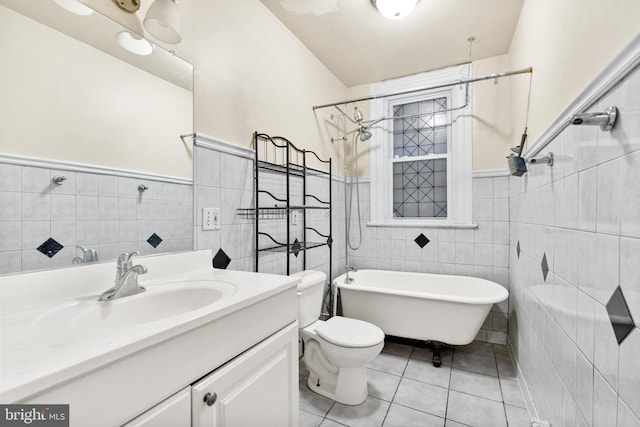 full bathroom with tile walls, tile patterned floors, vanity, and toilet