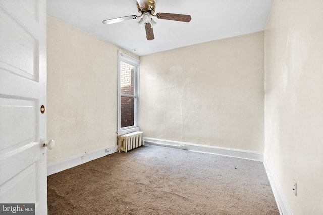 spare room featuring carpet floors, radiator heating unit, and ceiling fan