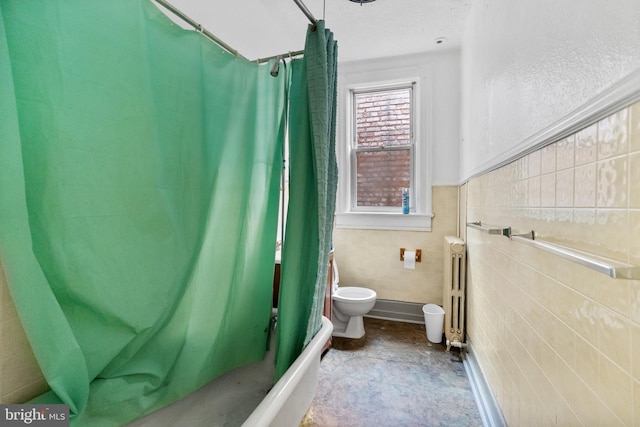 bathroom featuring radiator, tile walls, toilet, and shower / bath combo