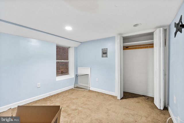 unfurnished bedroom featuring light carpet and a closet