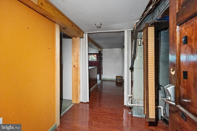 hallway with dark hardwood / wood-style flooring