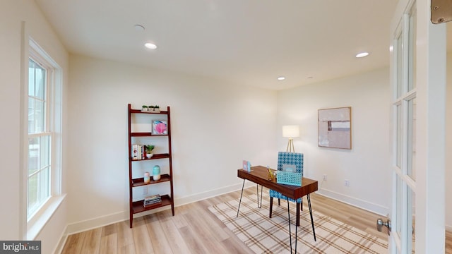 home office with light hardwood / wood-style floors