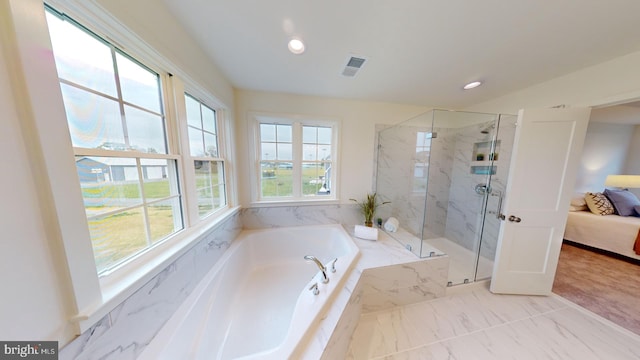 bathroom with separate shower and tub