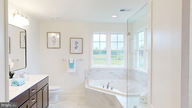 bathroom with vanity, a relaxing tiled tub, and toilet