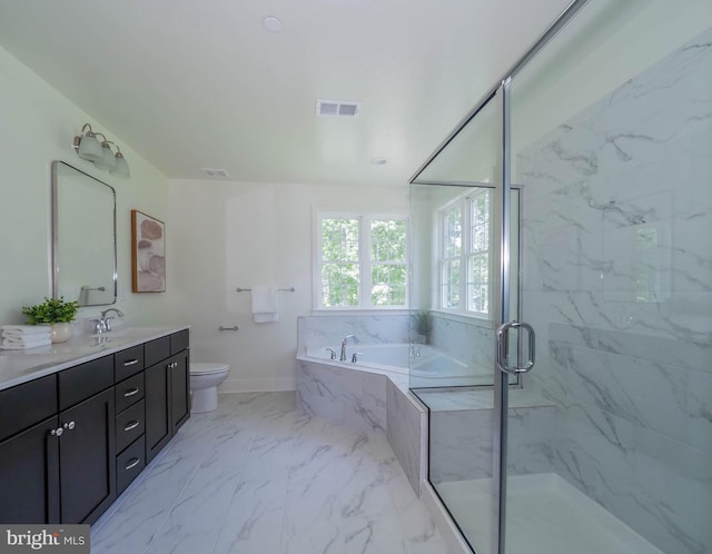 full bathroom featuring separate shower and tub, vanity, and toilet