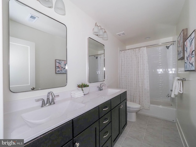 full bathroom featuring shower / bath combo with shower curtain, tile patterned floors, vanity, and toilet