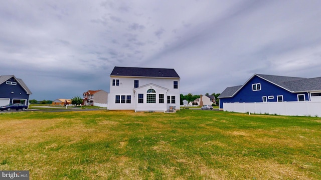 rear view of property with a yard