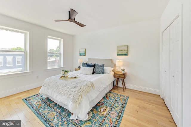 bedroom featuring wood-type flooring, a closet, and ceiling fan