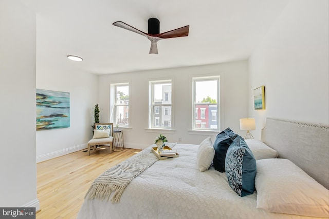 bedroom with ceiling fan and hardwood / wood-style flooring