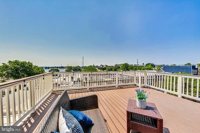 wooden terrace featuring a water view