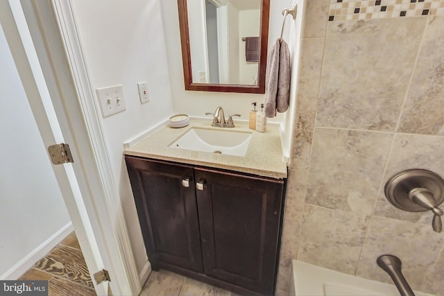 bathroom featuring walk in shower and vanity