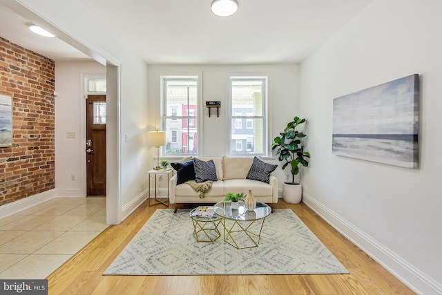 living room featuring wood-type flooring and brick wall