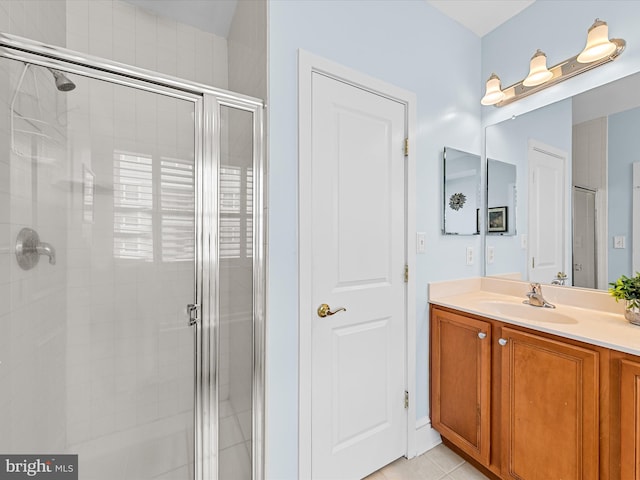 bathroom with tile patterned flooring, an enclosed shower, and vanity