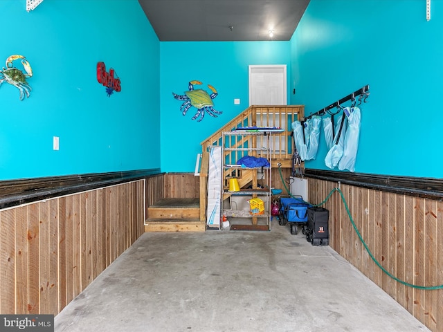 interior space with wood walls and concrete flooring