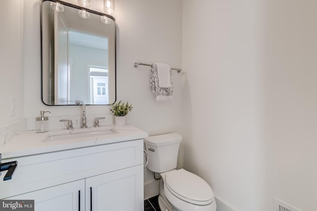 bathroom featuring vanity and toilet