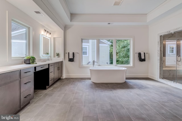 bathroom with plus walk in shower, vanity, plenty of natural light, and ornamental molding