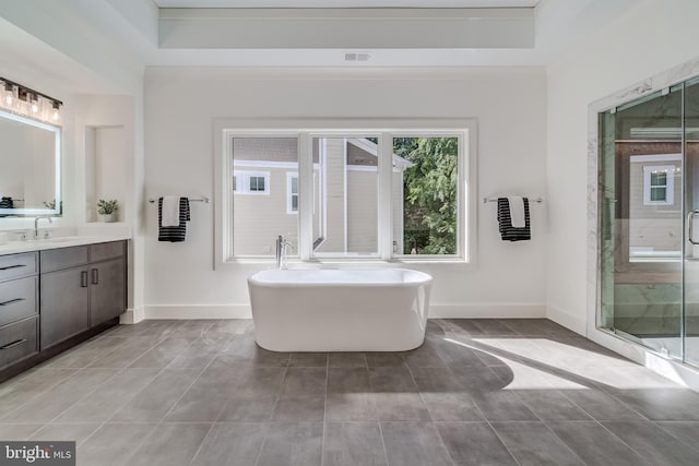 bathroom with vanity and independent shower and bath