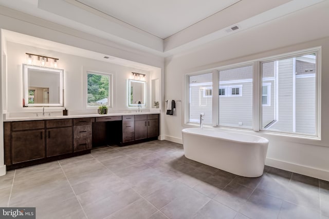 bathroom featuring vanity, tile patterned floors, and a bathing tub