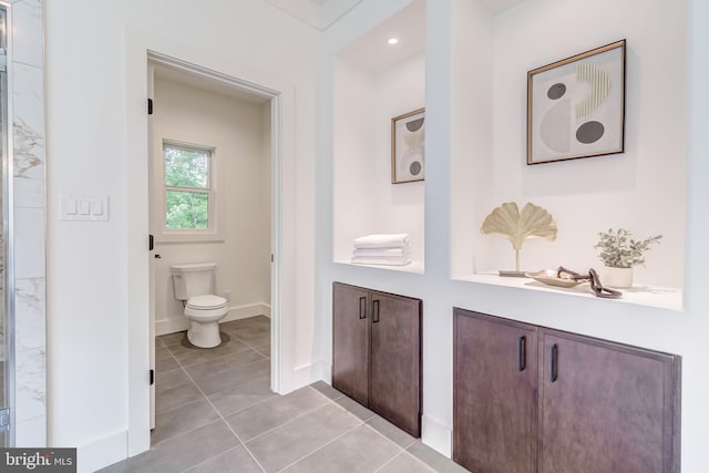 bathroom with tile patterned floors and toilet