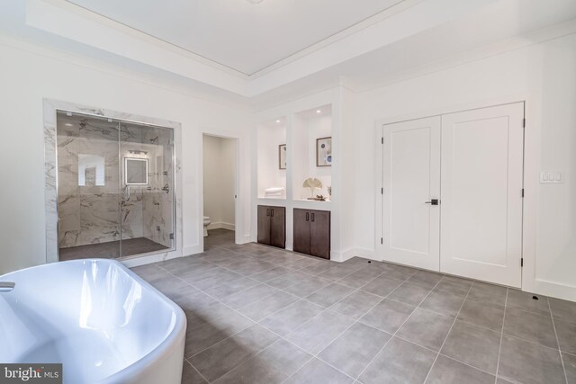 bathroom featuring tile patterned flooring, ornamental molding, toilet, and independent shower and bath