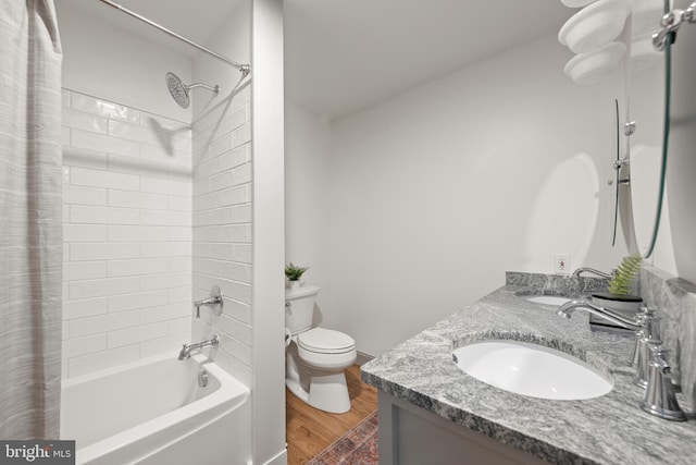 full bathroom with shower / tub combo, hardwood / wood-style floors, vanity, and toilet