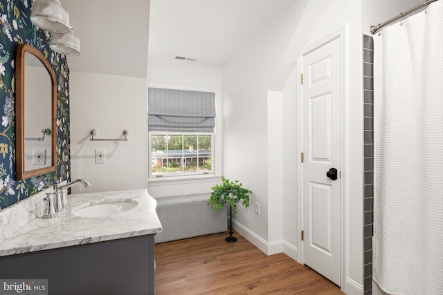 bathroom featuring vanity, radiator heating unit, and hardwood / wood-style flooring