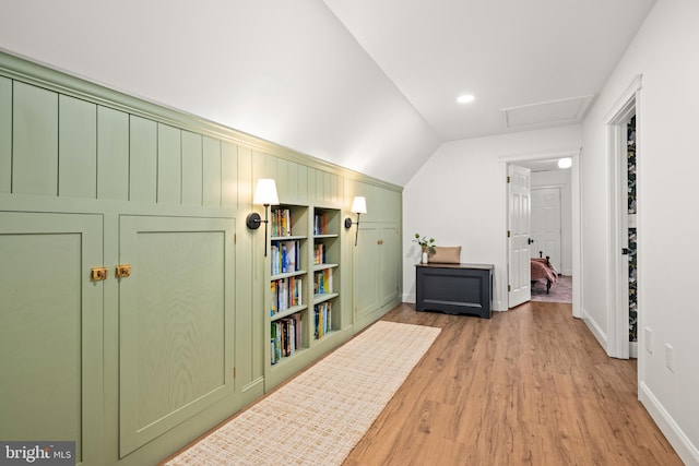 hallway featuring light hardwood / wood-style flooring and vaulted ceiling