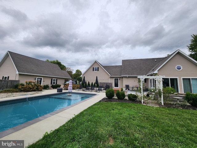 view of pool with a lawn and a patio