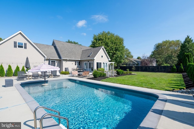 view of swimming pool with a yard and a patio