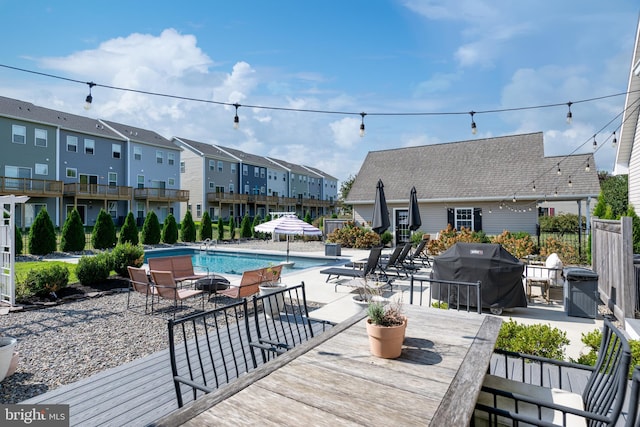 view of pool featuring a patio area and grilling area